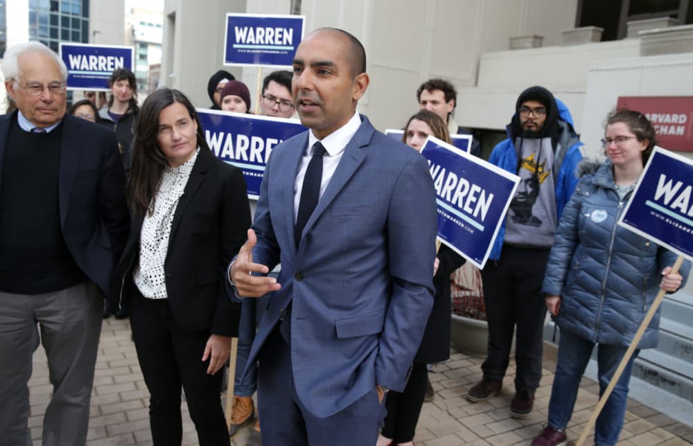 From left, Don Berwick, Dr. Kathryn Stephenson, and state Rep. Jon Santiago show support for presidential candidate Elizabeth Warren in 2020. (Jonathan Wiggs/The Boston Globe via Getty Images)