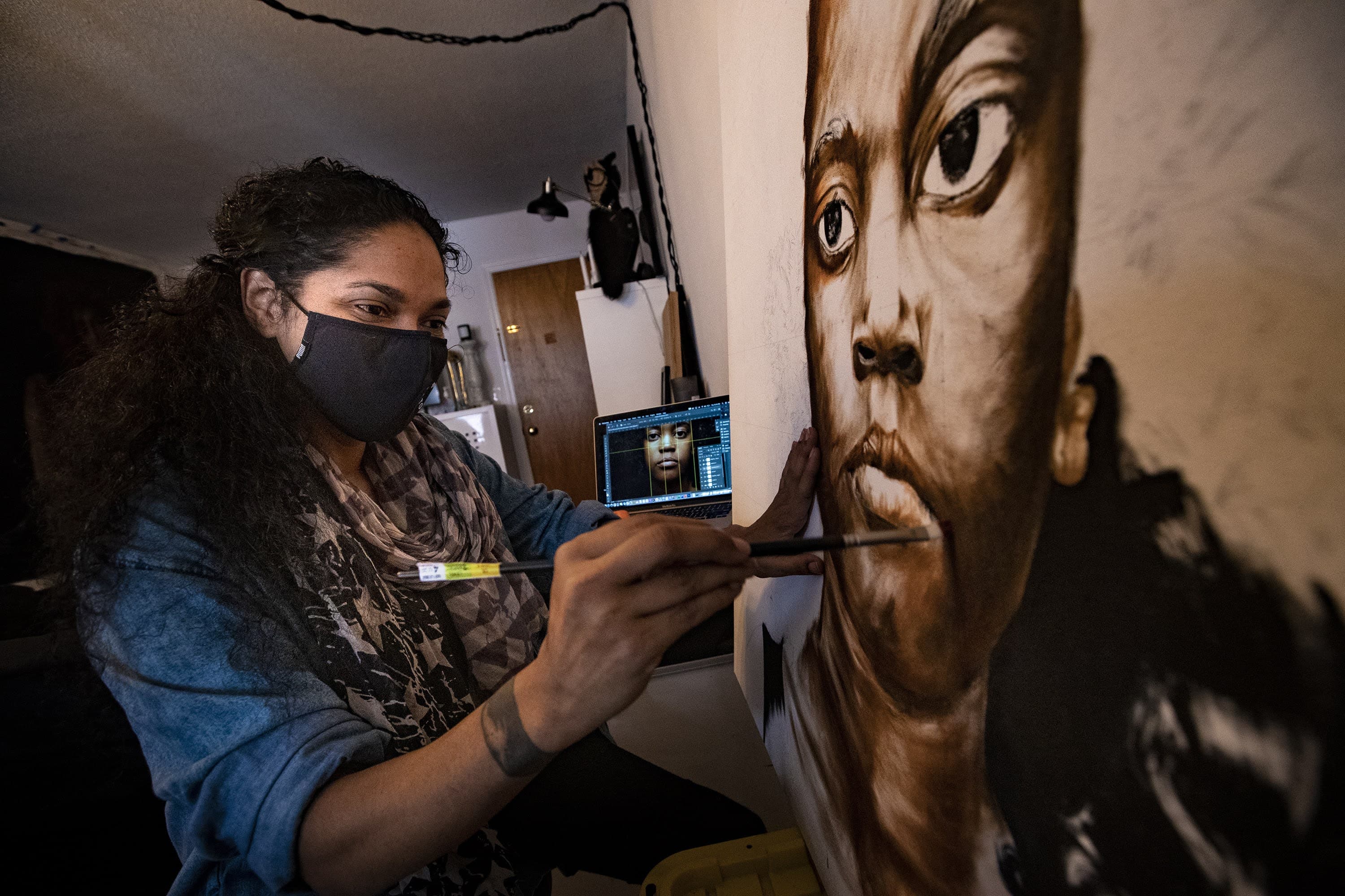 Artist Marla McLeod works on a piece featuring her niece at her studio in New Haven. (Jesse Costa/WBUR)
