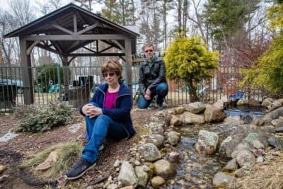 Lee Brooks lost her son to leukemia, and Brian Dellascio had Hodgkin lymphoma as a teen. They're pictured outside Brooks' Wilmington home. (Jesse Costa/WBUR)