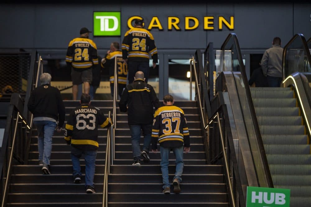 Bruins fans walk up the stairs toward the entrance of TD Garden. (Jesse Costa/WBUR)