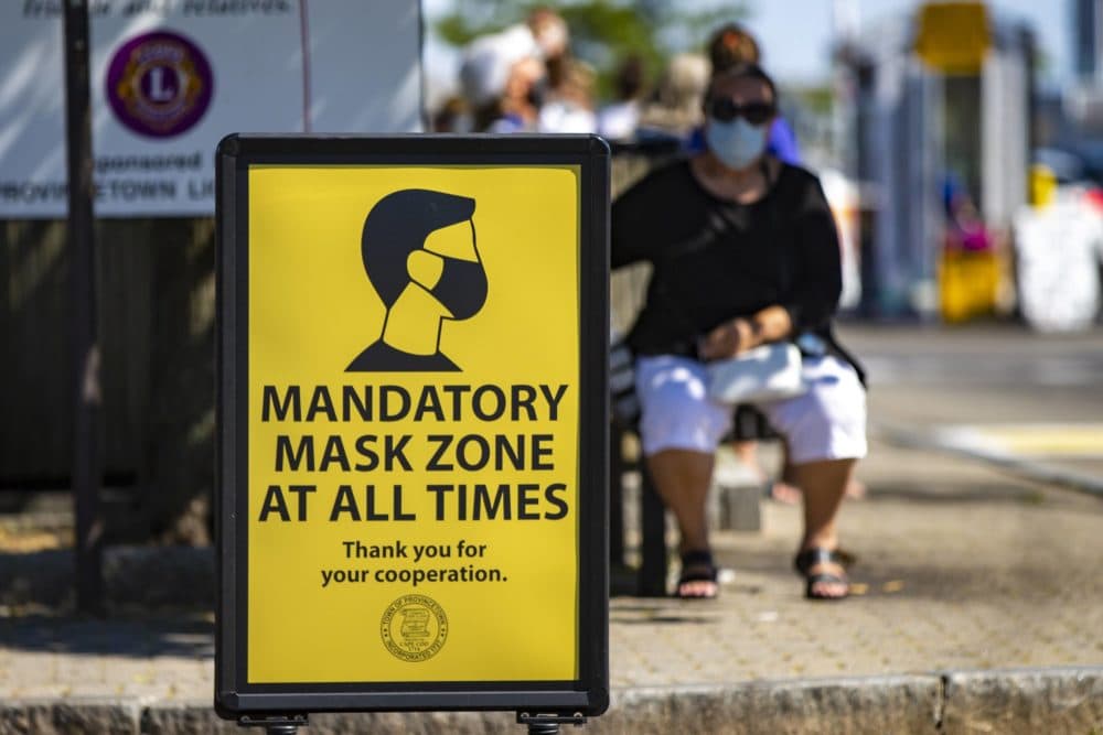 In this July 2020 photo, signs are posted around the business district of Provincetown reminding people to wear a mask in public to help prevent the spread of coronavirus. (Jesse Costa/WBUR)