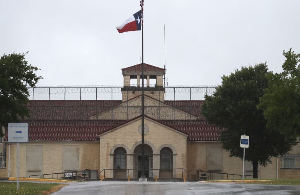 A Texas flag flies in front of the Federal Medical Center prison in Fort Worth, Texas, on May 16, 2020. (LM Otero/AP)