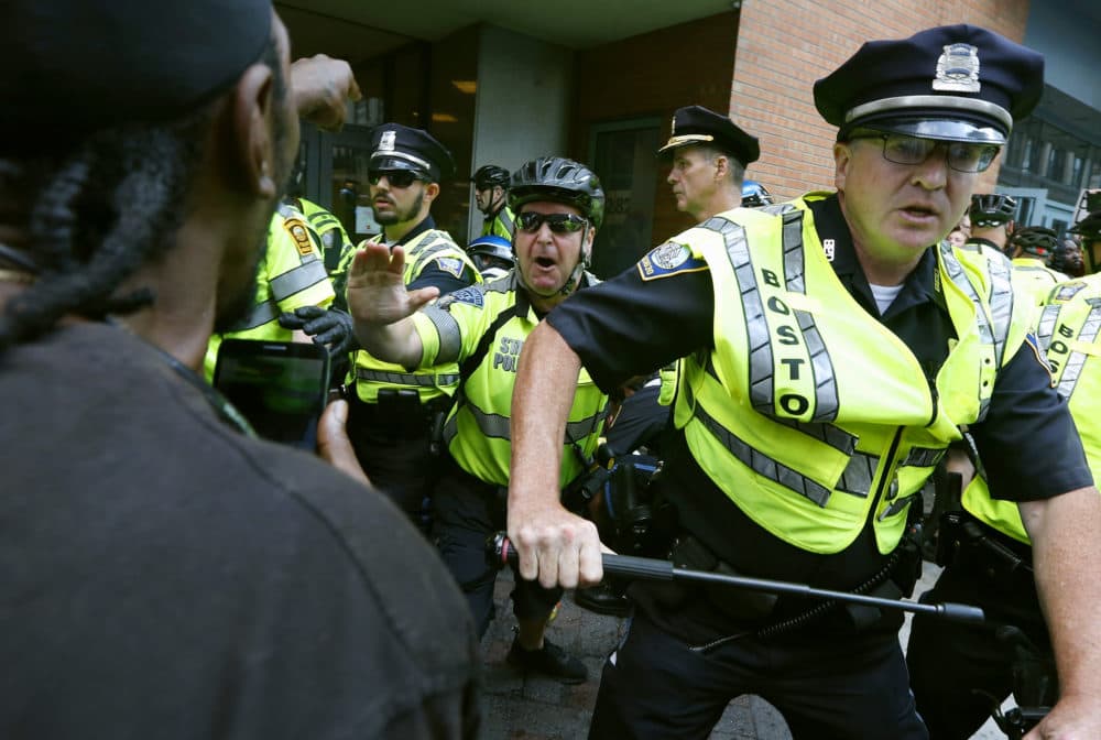 In this Aug. 19, 2017, file photo, counterprotesters clash with police following a &quot;Free Speech&quot; rally staged by conservative activists in Boston. (Michael Dwyer/AP File)