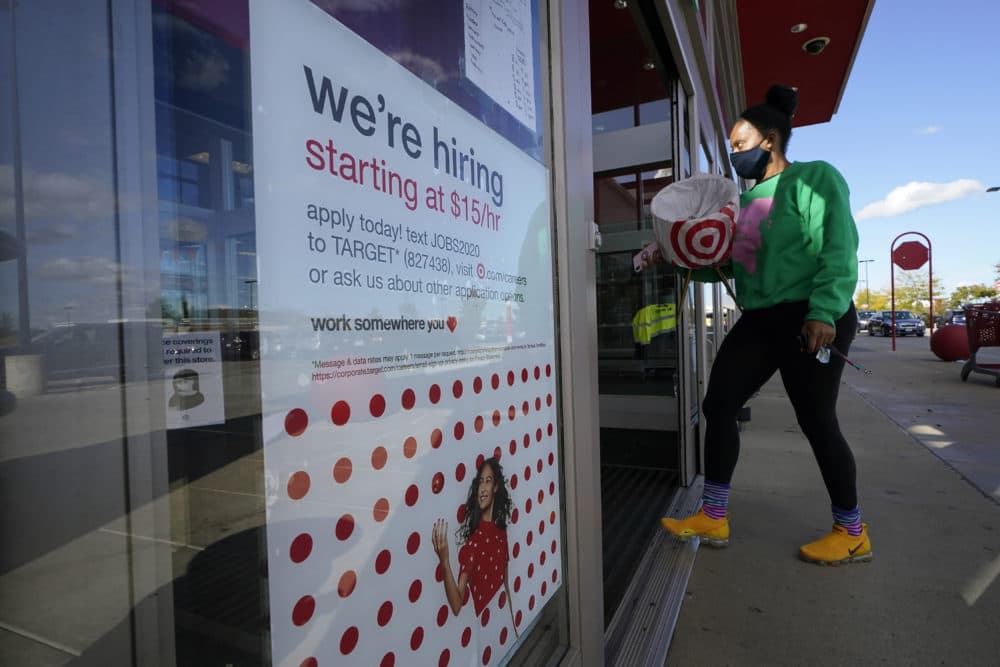In this Sept. 30, 2020, file photo, a passerby walks past a hiring sign while entering a Target store in Westwood, Mass. (Steven Senne/AP File)