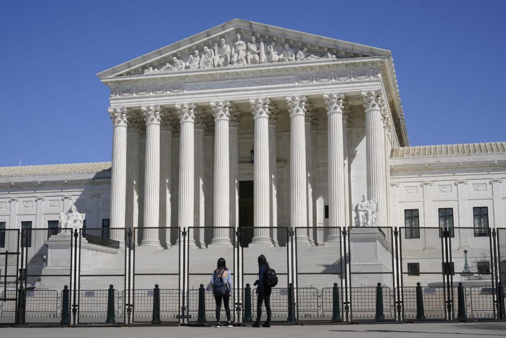 People view the Supreme Court building from behind security fencing on Capitol Hill in Washington, March 21, 2021, after portions of an outer perimeter of fencing were removed overnight to allow public access. (Patrick Semansky)