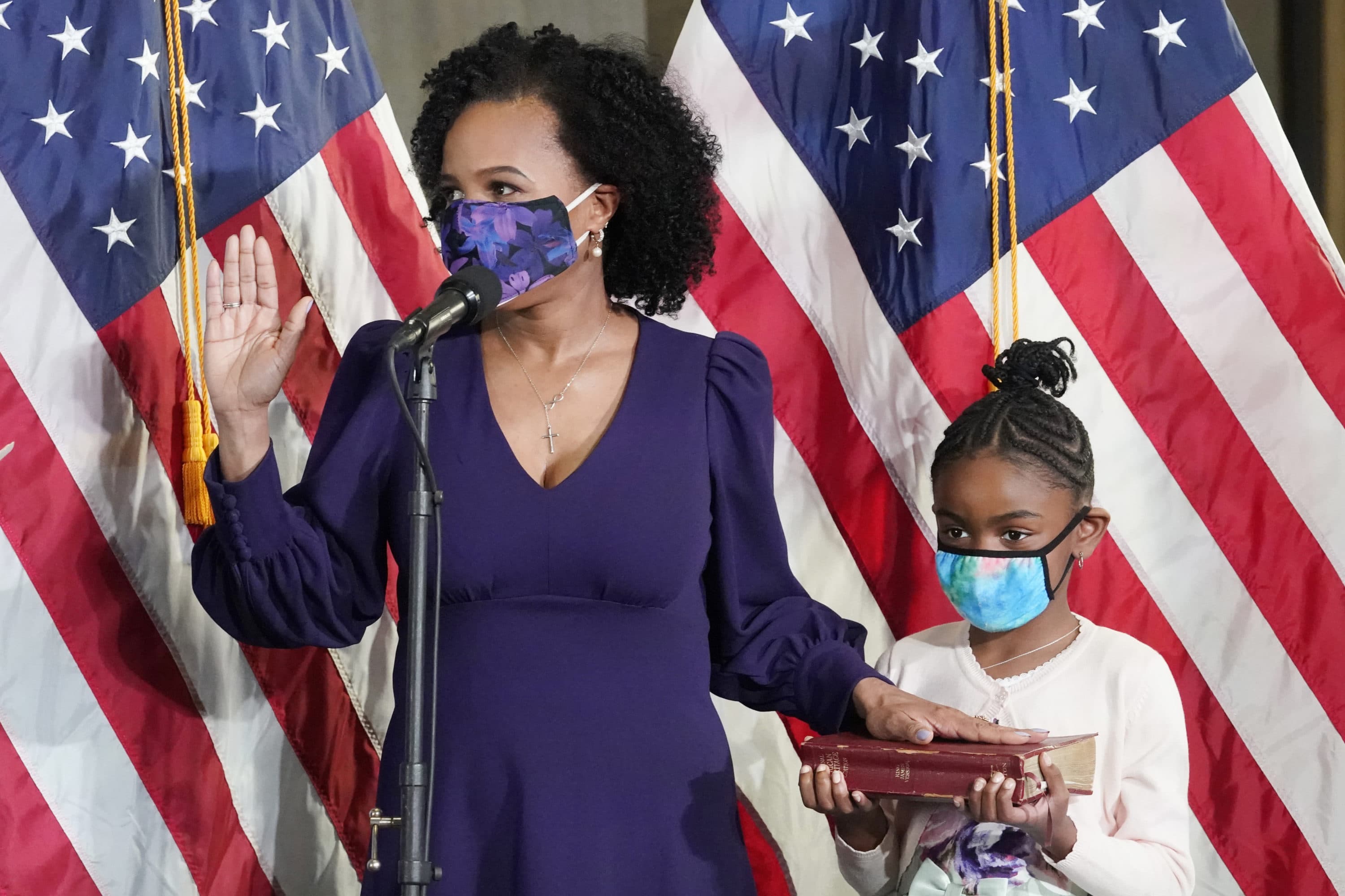 Former Boston City Council President Kim Janey is sworn in as Boston's new mayor at City Hall while her granddaughter, Rosie, holds a Bible, on March 24 in Boston. (Elise Amendola/AP)