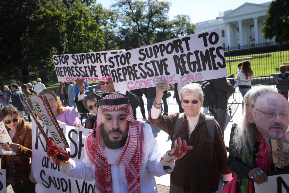 A protester dressed as Saudi Arabian crown prince Mohammad bin Salman, demonstrates with members of the group Code Pink outside the White House in the wake of the disappearance of Saudi Arabian journalist Jamal Khashoggi October 19, 2018 in Washington, DC. (Win McNamee/Getty Images)