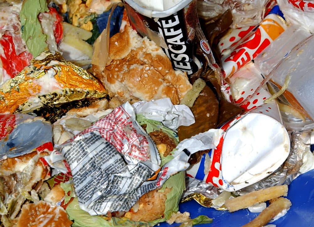 Trash overflows from a fast food restaurant's waste bin. (John Li/Getty Images)