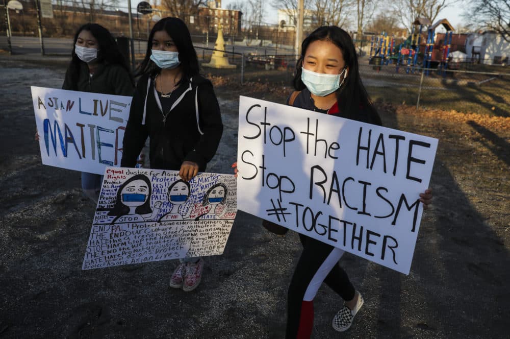 Children carry &quot;stop the hate&quot; and &quot;Asian lives matter&quot; as they walk around Clemente Park in Lowell, Mass. during a vigil held for the victims of the shooting spree in Atlanta on March 17, 2021. (Erin Clark/The Boston Globe via Getty Images)