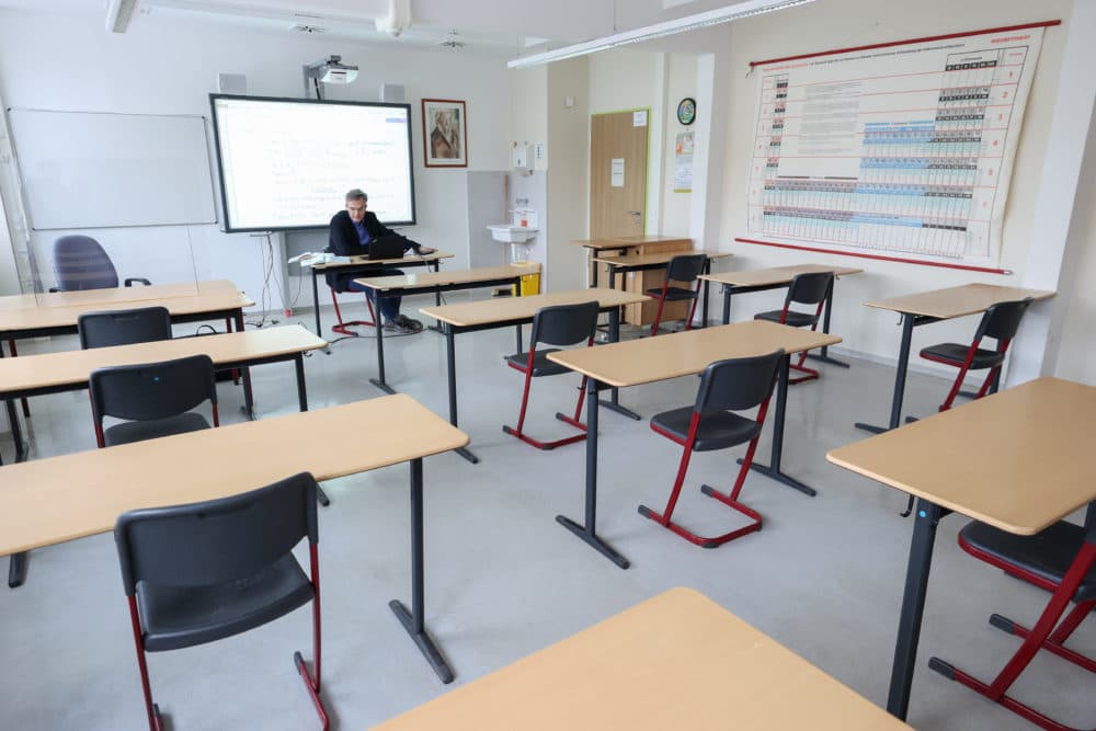 Steffen Jost, principal of Ostwaldgymnasium in Leipzig, Germany, holds an advanced physics class online from an empty classroom on Oct. 15, 2020. (Jan Woitas/picture alliance via Getty Images)