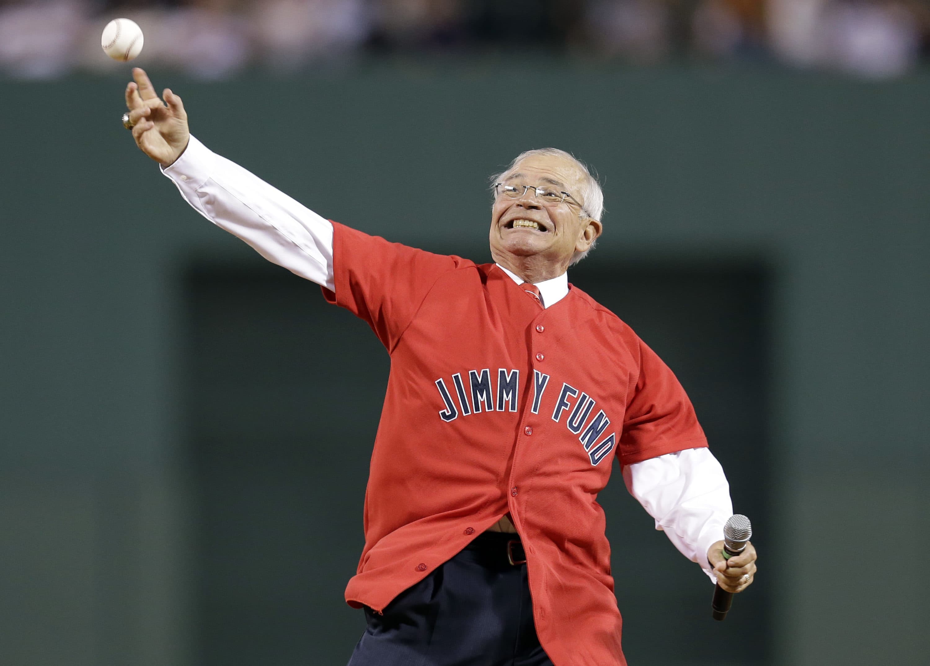Veteran Boston Red Sox radio broadcaster Joe Castiglione throws a ceremonial first pitch prior to a baseball game against the New York Yankees at Fenway Park in Boston on Sept. 12, 2012. (Elise Amendola/AP)