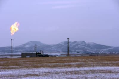 A gas flare is seen at a natural gas processing facility near Williston, North Dakota, in 2015. A team led by researchers at the University of Michigan has found that fossil fuel production at the Bakken Formation in North Dakota and Montana is emitting roughly 2% of the ethane detected in the Earth's atmosphere. (Matthew Brown/AP)