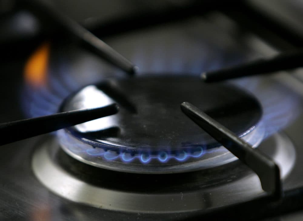 A gas-lit flame burns on a natural gas stove. (Thomas Kienzle/AP)