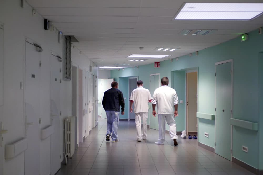 Medical staff of the emergency ward of the Rouvray psychiatric hospital accompany a patient to his room, in France on Nov. 25, 2020. (Thibault Camus/AP)