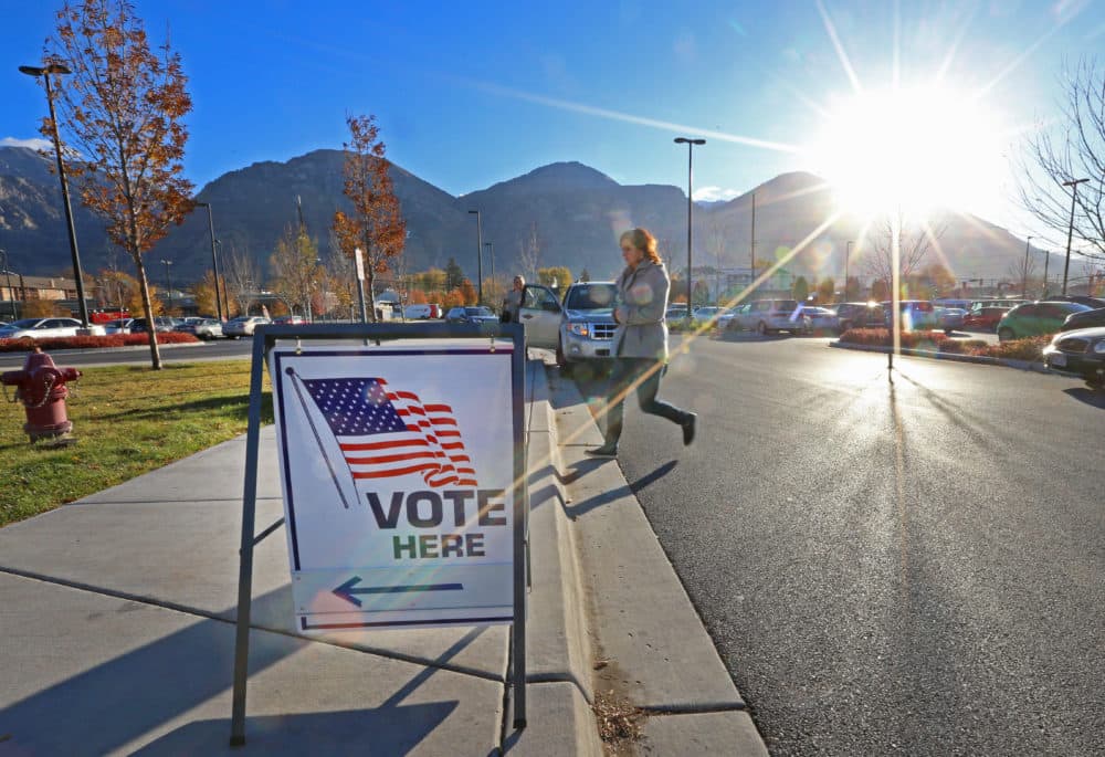 A woman walks into a polling center to vote in the midterm elections as the morning sun rises over the Utah Wasatch Mountains on November 6, 2018 in Provo, Utah. (George Frey/Getty Images)