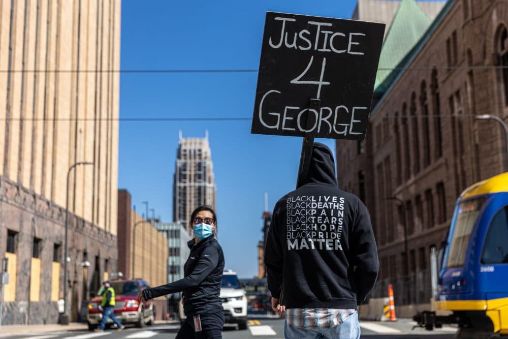 A demonstrator hold a sign &quot;Justice for George&quot; outside the Hennepin County Government Center during the opening statement of former Minneapolis Police officer Derek Chauvin on March 29, 2021 in Minneapolis, Minnesota. (Kerem Yucel/AFP via Getty Images)