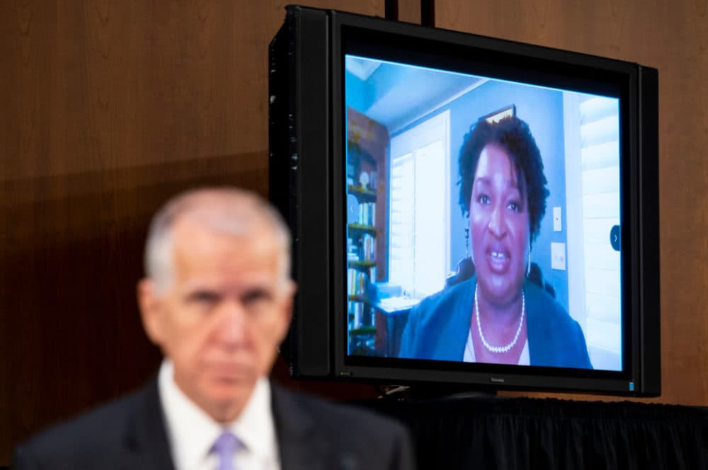 Sen. Thom Tillis, R-N.C., left, listens as Stacey Abrams, founder of Fair Fight Action, speaks during the Senate Judiciary Committee hearing on Jim Crow 2021: The Latest Assault on the Right to Vote on Tuesday, April 20, 2021. (Bill Clark/CQ-Roll Call, Inc via Getty Images)
