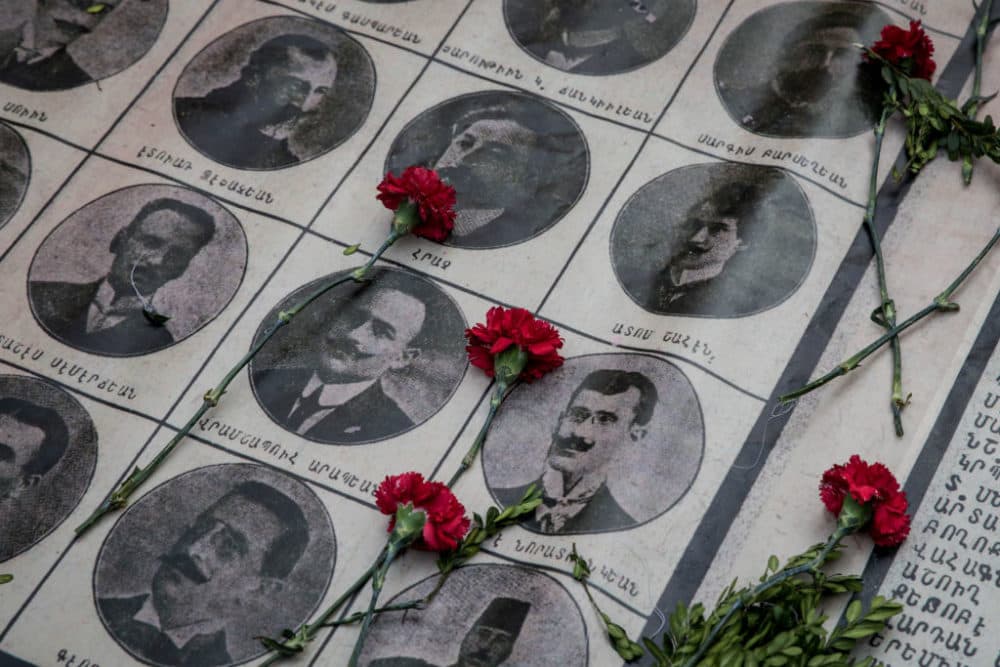 Roses lay on the portraits of victims during a memorial to commemorate the mass killings of Armenians in 1915 on April 24, 2018 in Istanbul, Turkey. (Chris McGrath/ Getty Images)
