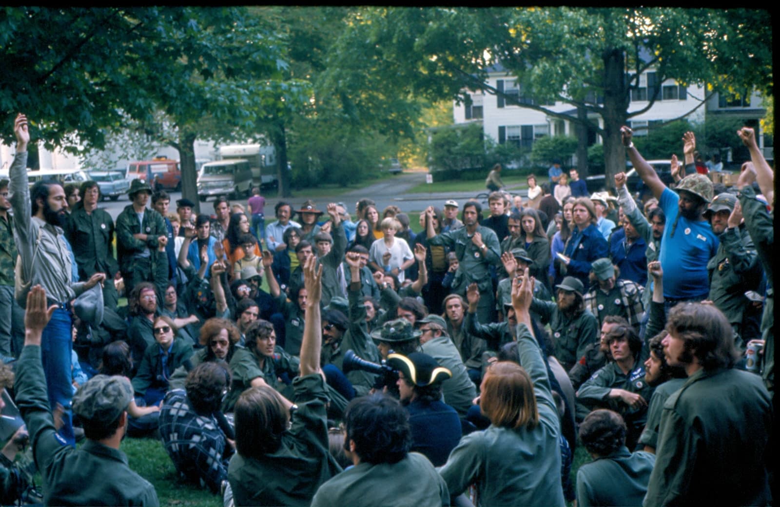 Chris Gregory (seated on lower right with Air Force wings on his fatigues) and other veterans take a vote on the green after being served an injunction from the Lexington Select Board about whether or not to commit civil disobedience. (Courtesy Richard Robbat)