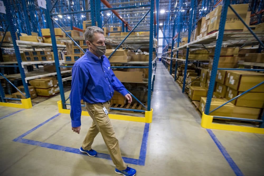 CEO Rick Green walks through the 1A Auto Parts distribution center in Littleton. (Jesse Costa/WBUR)