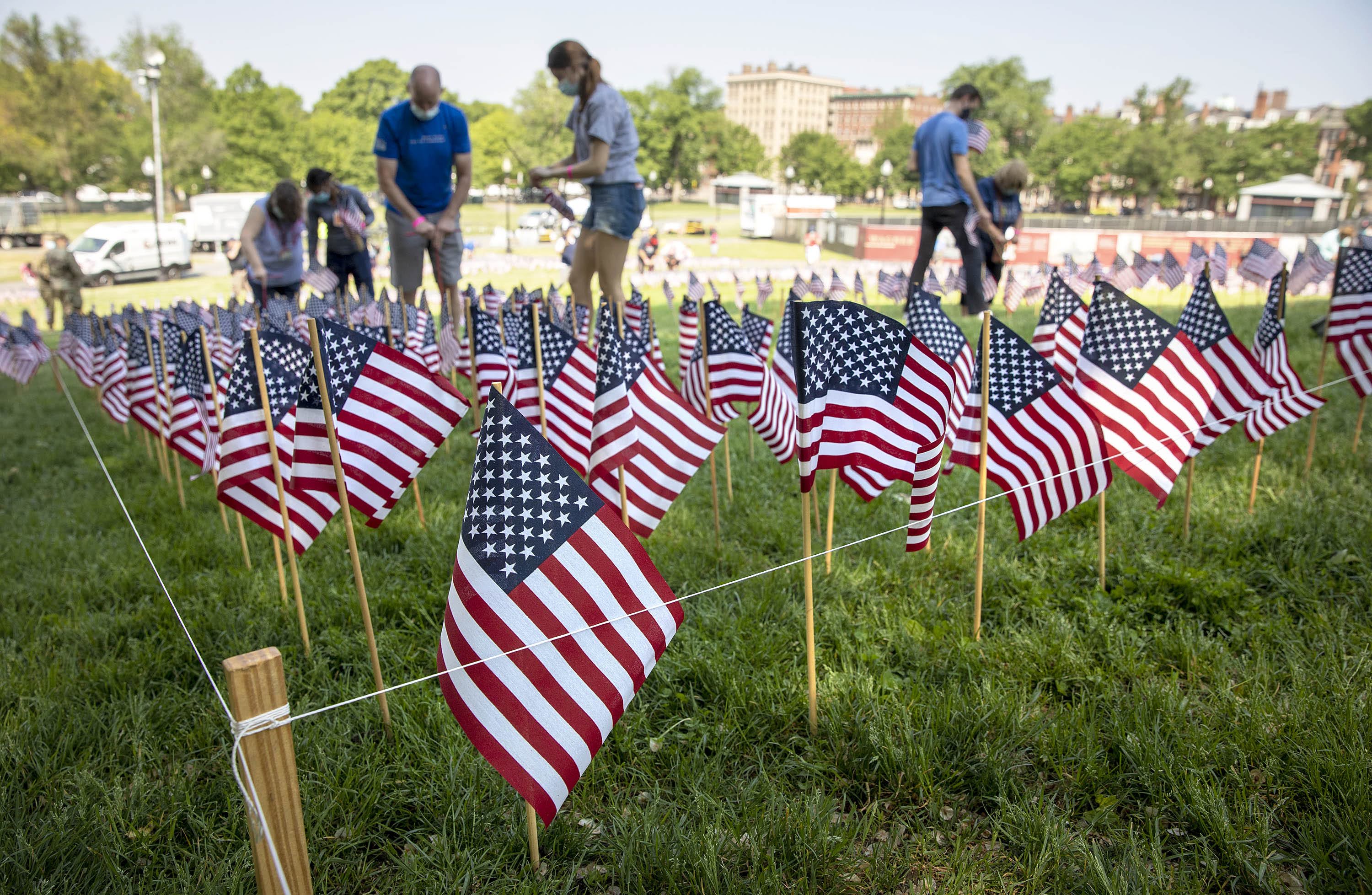Volunteers plant Memorial Day flags on Boston Common. (Robin Lubbock/WBUR)