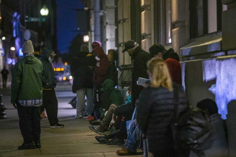 People experiencing homelessness last fall stand in line outside a Boston shelter. (Jesse Costa/WBUR)