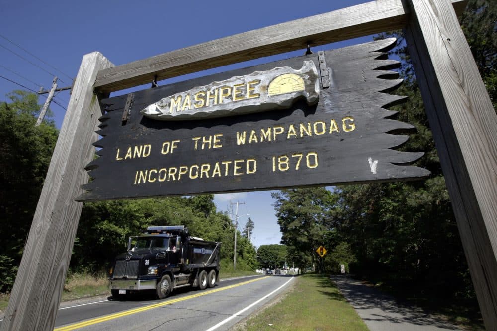 In this June 25, 2018, photo, a wooden sign advises motorists of the location of Mashpee Wampanoag Tribal lands in Massachusetts. (Steven Senne/AP File)
