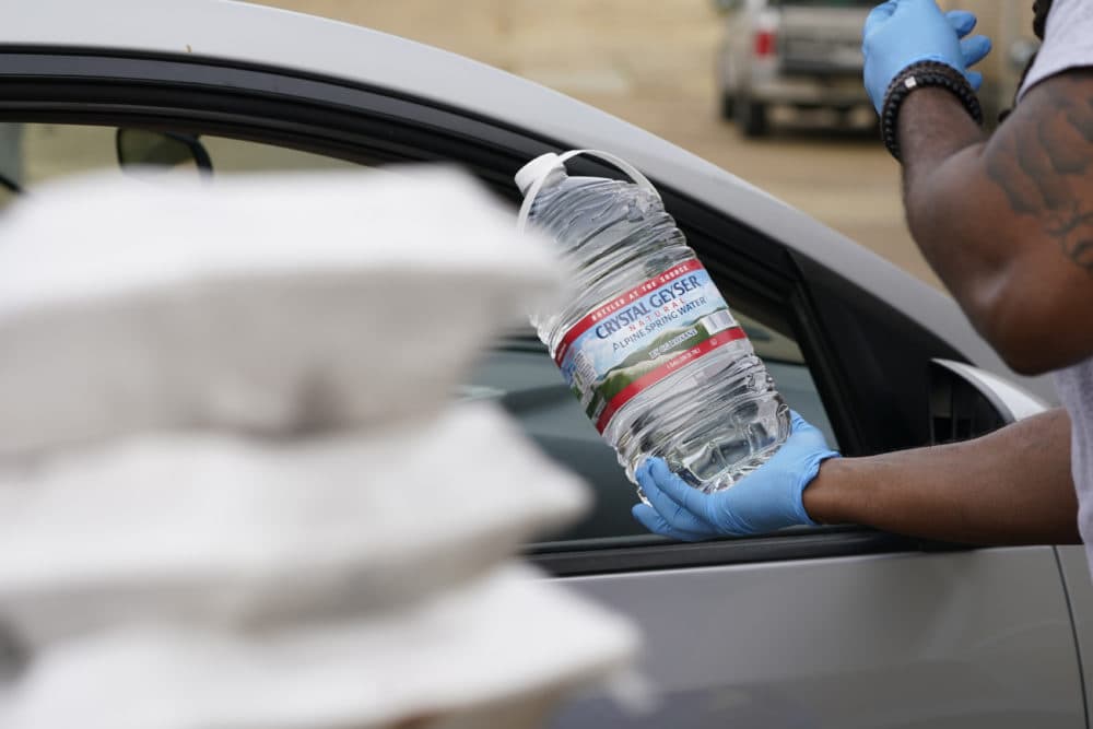 The faculty and students at Provine High School served prepared meals and distributed bottled water to residents in Jackson, Mississippi, on March 11, 2021. The Jackson Public School District set up sites at several schools to help residents who still are under a boil water notice. (Rogelio V. Solis/AP)