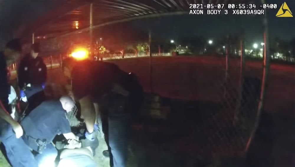 This photo taken from Providence Police body camera shows officers responding to a call Friday, May 7, 2021 of a man who was screaming outside in Providence, R.I. State authorities are investigating the case of the man who died after being handcuffed by police. (Providence Police Department via AP)