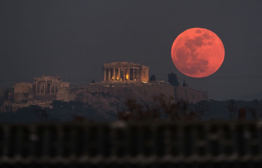 A super blue blood moon rises behind the 2,500-year-old Parthenon temple on the Acropolis of Athens, Greece on Jan. 31, 2018. (Petros Giannakouris/AP)