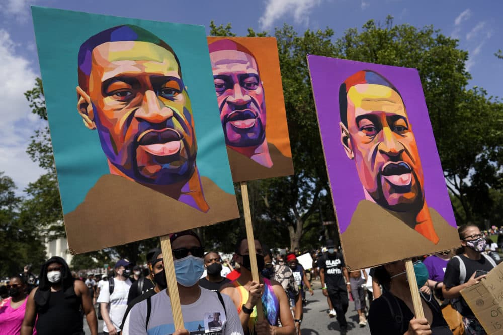 People carry posters with George Floyd on them as they march from the Lincoln Memorial to the Martin Luther King Jr. Memorial in Washington, D.C. (Carolyn Kaster/AP)