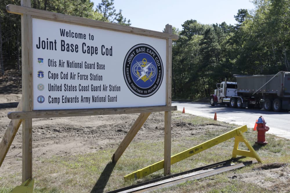 A truck drives past a welcome sign to Joint Base Cape Cod, Monday, Sept. 22, 2014, in Sandwich, Mass. (AP Photo/Steven Senne)