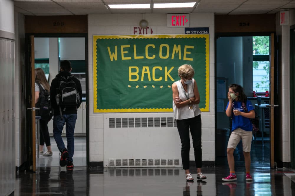 A teacher speaks with a student between classes at Rippowam Middle School on September 14, 2020 in Stamford, Connecticut. (John Moore/Getty Images)