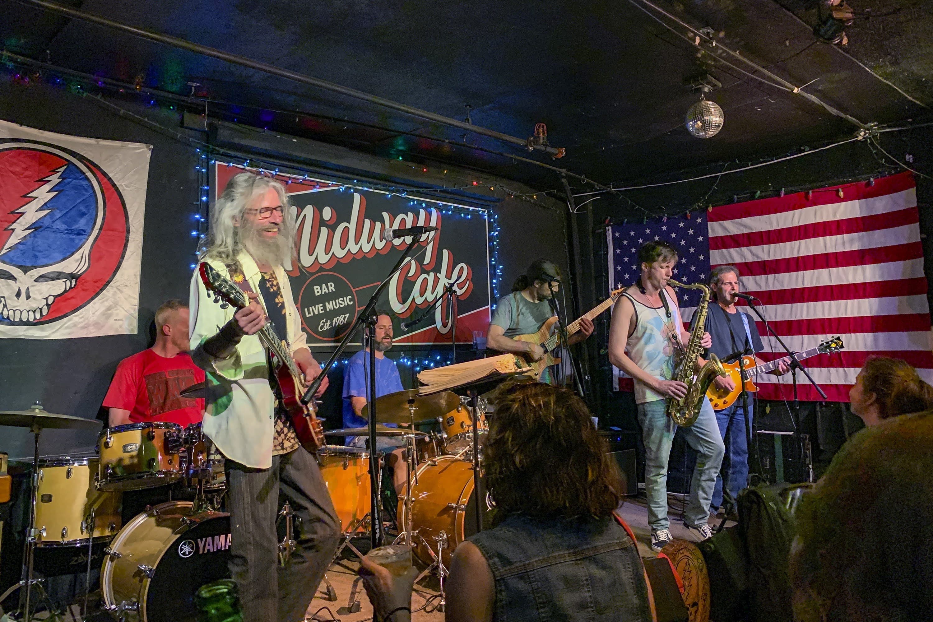 The Mystical Misfits perform with guest drummer &quot;Uncle Johnny&quot; Frazee during the Hippie Hour at the Midway Cafe on the 10th anniversary of the popular weekly Grateful Dead residency. (Amelia Mason/WBUR)