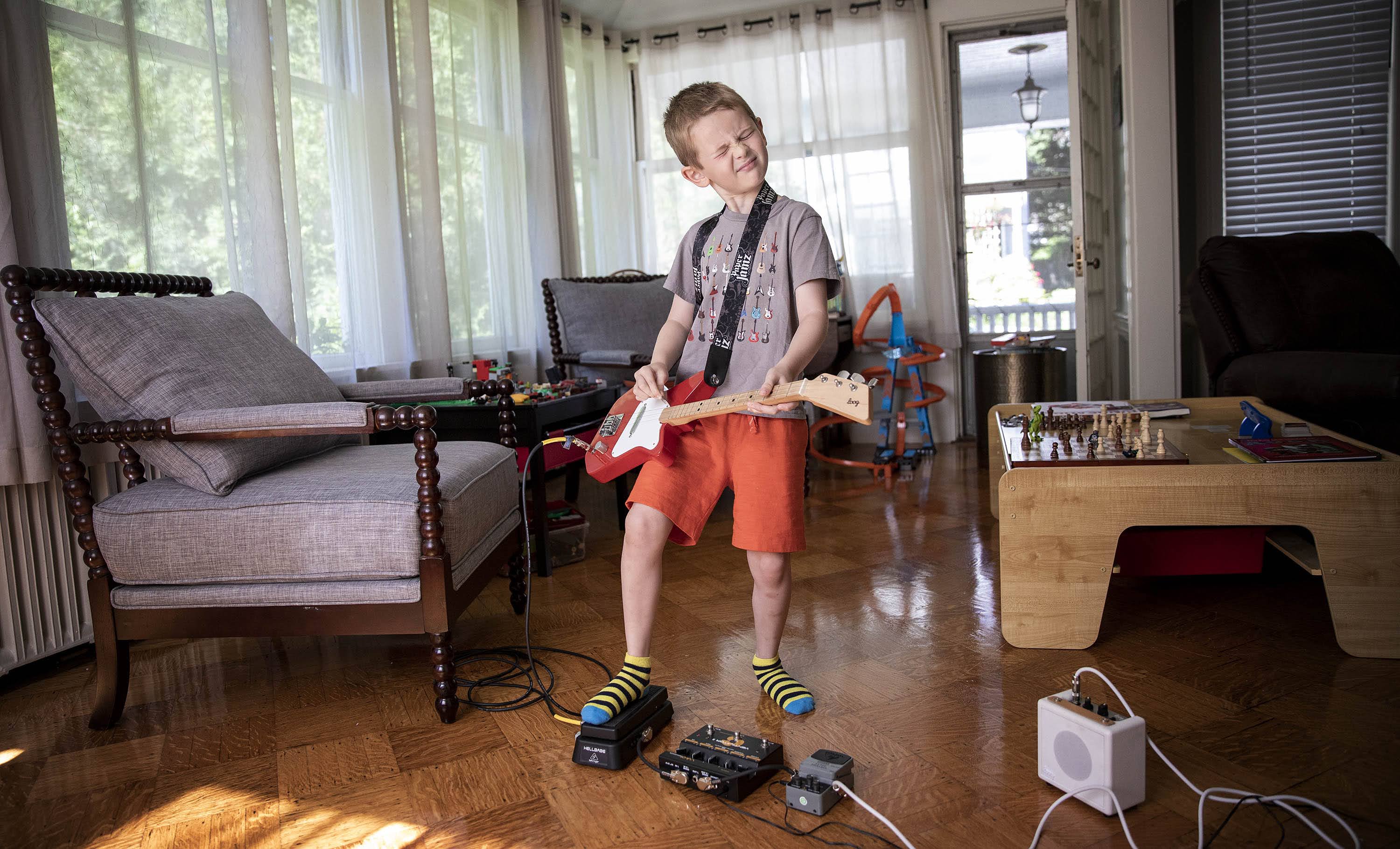 Arlen gets in some practice on his electric guitar. The young musician is the inspiration for &quot;The Boy Who Wanted to Rock,&quot; written by his father Dave Weiser. (Robin Lubbock/WBUR)