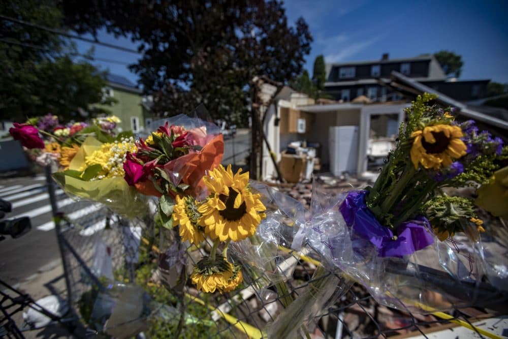 Flowers were hung near the scene of the vehicle crash and fatal shootings in Winthrop this weekend. (Jesse Costa/WBUR)