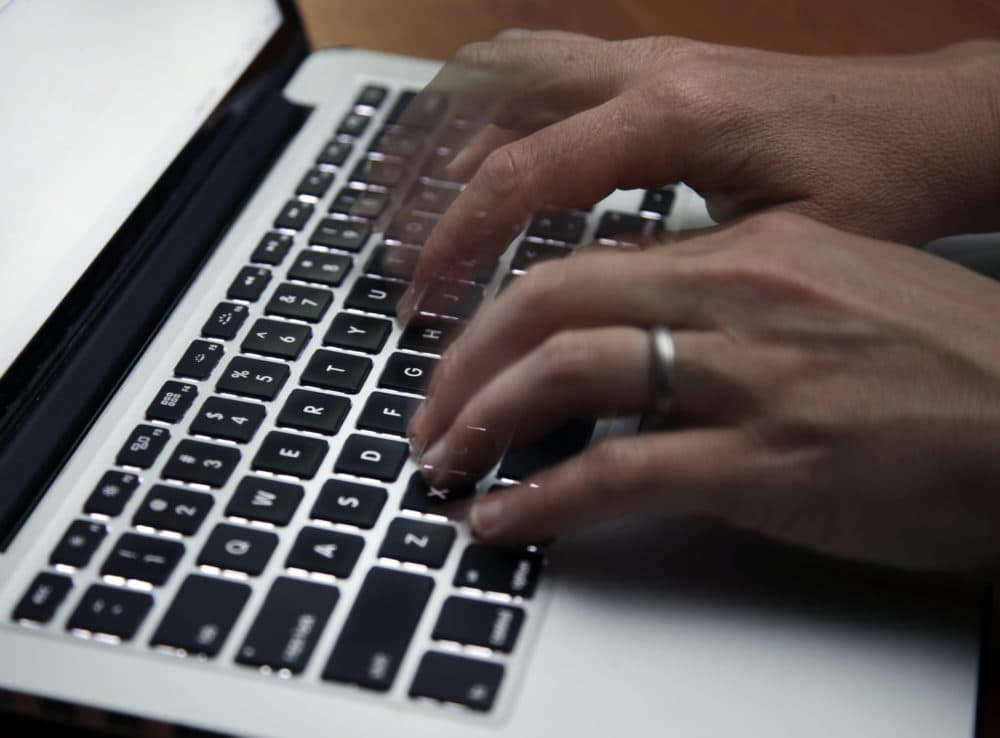 A person working on a laptop. (Elise Amendola/AP)