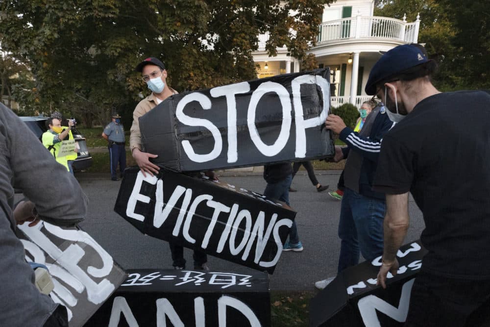 In this Oct. 14, 2020, file photo, housing activists erect a sign in front of Massachusetts Gov. Charlie Baker's house in Swampscott, Mass. (Michael Dwyer/AP File)