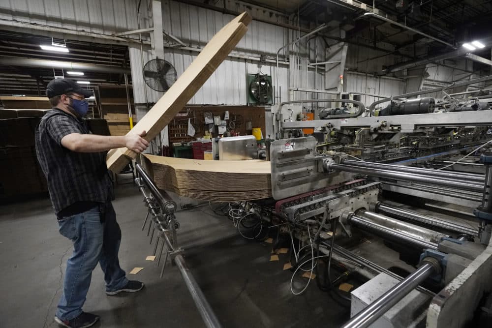Rob Bondurant, a supervisor at Great Southern Industries, a packaging company, loads up a finishing machine in the Jackson, Miss., facility, May 28, 2021. The lack of workers has forced some supervisors to assume additional duties. (Rogelio V. Solis/AP)