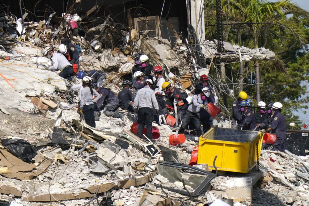 Rescue workers search in the rubble at the Champlain Towers South condominium, Monday, June 28, 2021, in the Surfside area of Miami. Many people are still unaccounted for after the building partially collapsed last Thursday. (Lynne Sladky/AP)