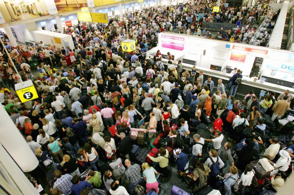 Crowds of passengers are pictured in the South terminal at Gatwick Airport in Sussex, England in August 2006.(Carl De Souza/AFP via Getty Images)