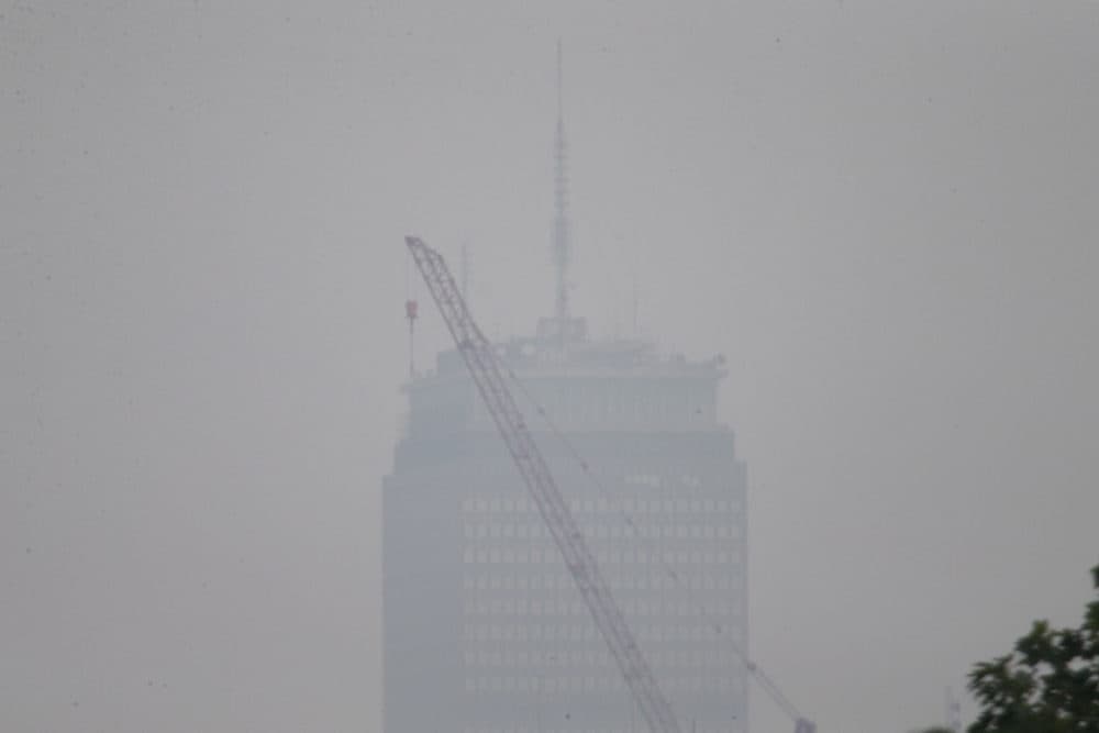 A view of the Prudential Tower from Somerville on Monday afternoon. Smoke from the wildfires from the western part of the country and Canada returned to Boston. (Jesse Costa/WBUR)