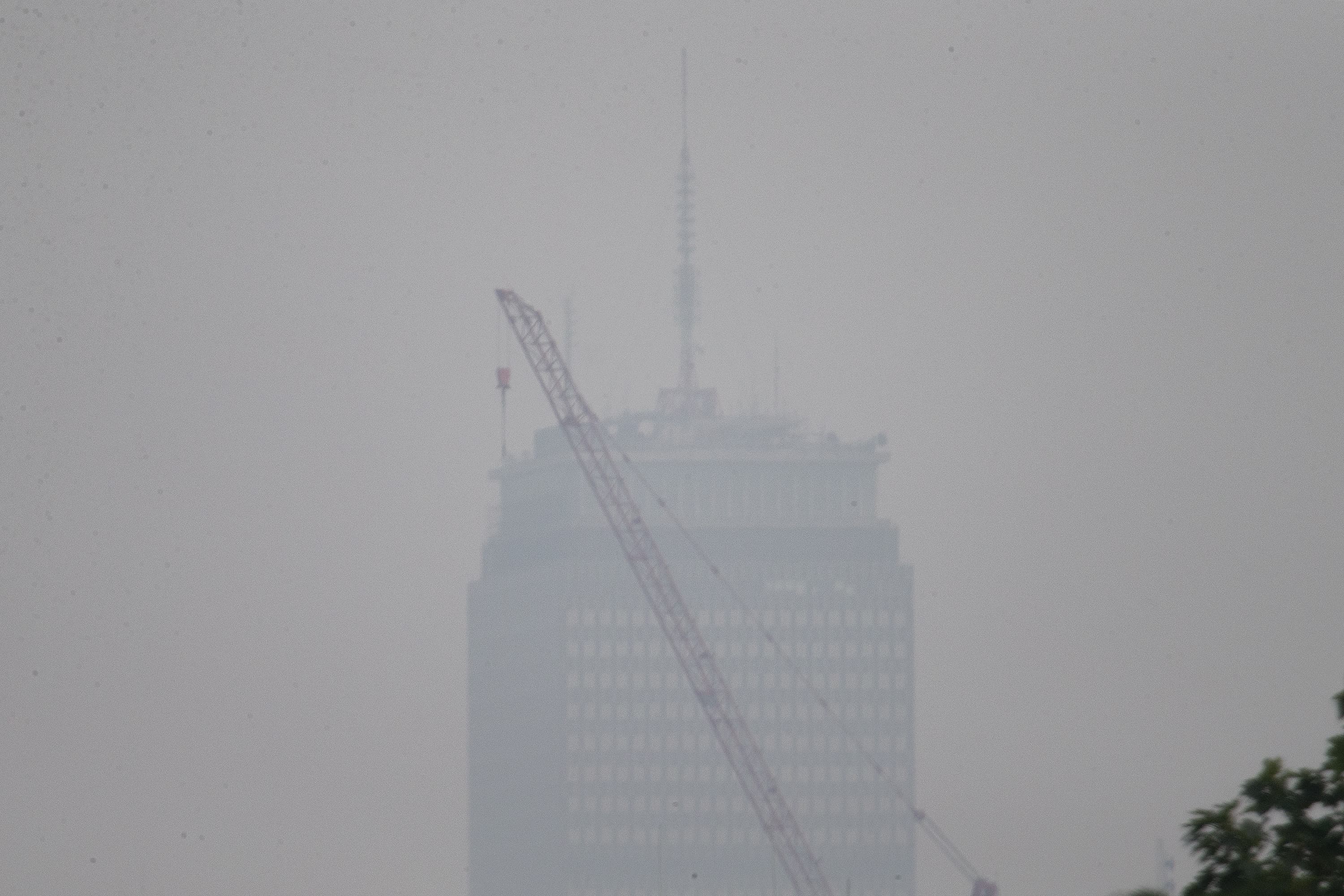 A view of the Prudential Tower from Somerville on Monday afternoon. Smoke from the wildfires from the western part of the country and Canada returned to Boston. (Jesse Costa/WBUR)