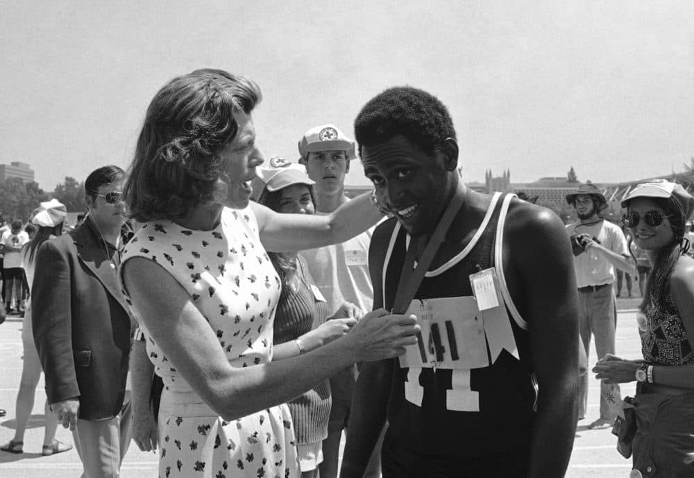 In this Aug. 17, 1972, file photo, Adonis Brown, 18, of Baltimore, smiles as Eunice Kennedy Shriver hangs a gold medal around his neck after he won the mile run in five minutes, 12 seconds in the International Special Olympics in Los Angeles. (Wally Fong/AP File)