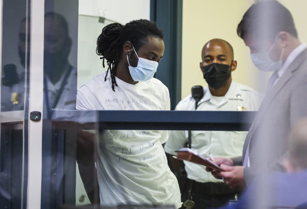 Conrad Pierre is arraigned at the Malden District Court on July 7, 2021 in Medford, Mass. Pierre is one of 11 people charged in connection with an armed standoff along a Massachusetts highway last weekend. (Erin Clark/The Boston Globe via AP, Pool)