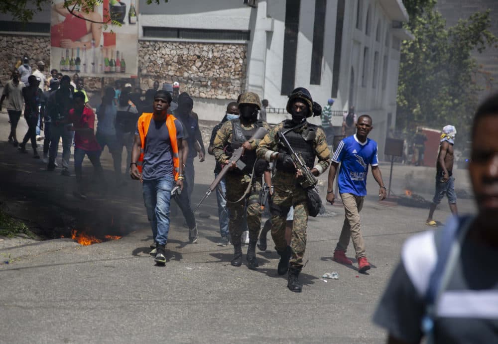 Police walk among protesters during a protest against the assassination of Haitian President Jovenel Moïse near the police station of Petion Ville in Port-au-Prince, Haiti, Thursday, July 8, 2021. (Joseph Odelyn/AP)