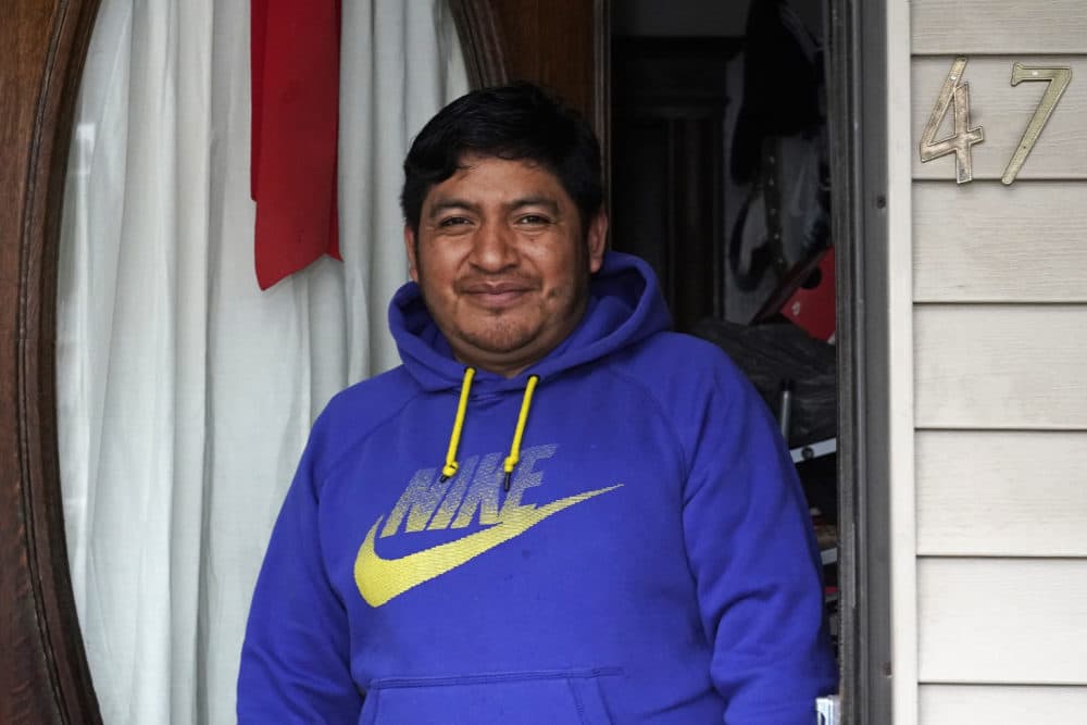 Lucio Perez poses in the front doorway of his home, where he has lived with his family since March, July 8, 2021, in Springfield. Just a few months ago, Perez moved out of a western Massachusetts church he'd lived in for more than three years to avoid deportation. (Charles Krupa/AP)