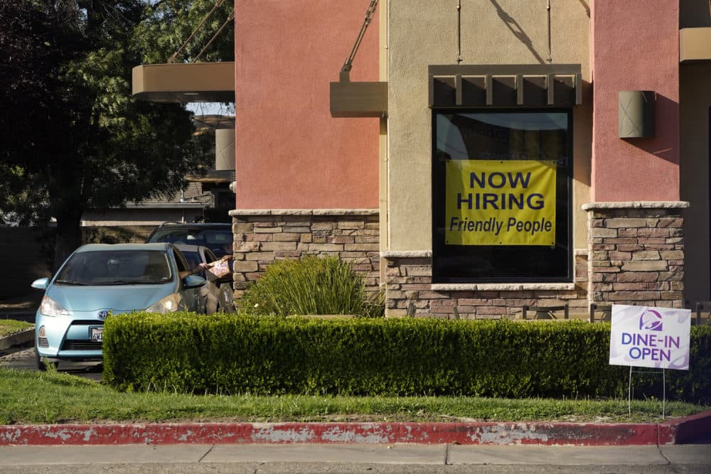 A hiring sign hangs in the window of a Taco Bell in Sacramento, Calif., July 15, 2021. (Rich Pedroncelli/AP)