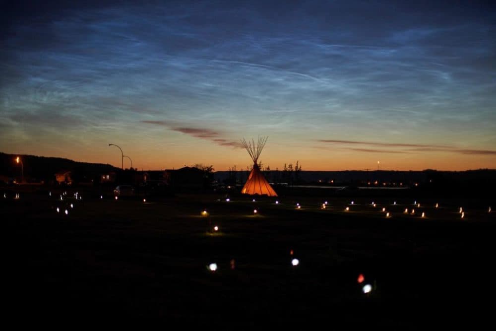 Solar lights and flags mark the spots where 751 human remains were recently discovered in unmarked graves at the site of the former Marieval Indian Residential School on the Cowessess First Nation in Saskatchewan on June 27, 2021. (Geoff Robins/AFP/Getty Images)