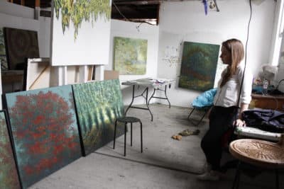 Painter Bethany Noël in her art studio at 57 Central St. in Somerville. (Jenn Stanley for WBUR)